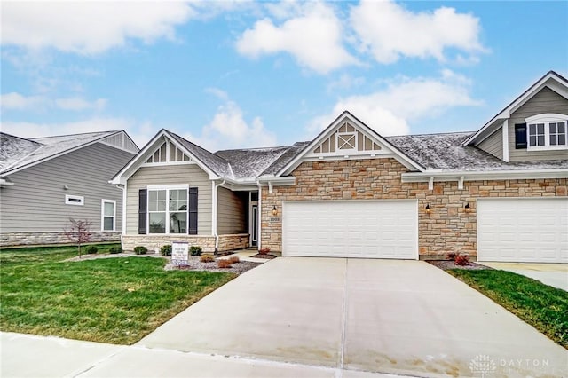 craftsman inspired home with a garage and a front lawn