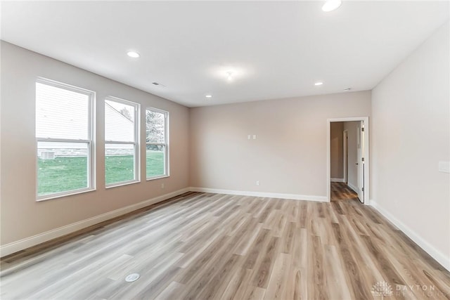 empty room with light hardwood / wood-style floors