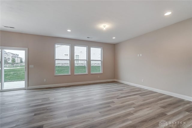 spare room with light hardwood / wood-style flooring