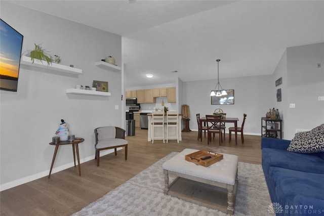 living room featuring light hardwood / wood-style flooring and a chandelier