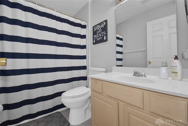 bathroom featuring toilet, a shower with curtain, vanity, and tile patterned floors