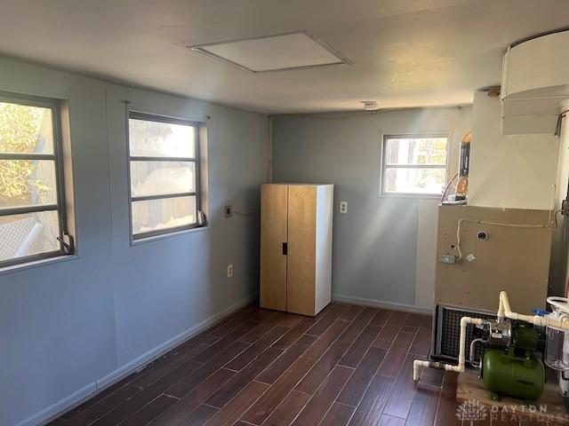 interior space featuring baseboards and wood finished floors