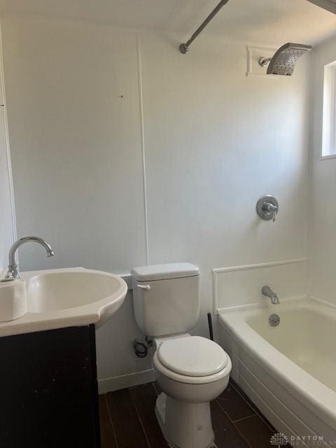 bathroom with shower / washtub combination, wood finish floors, vanity, and toilet