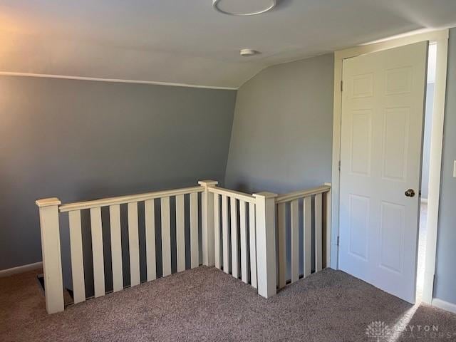 stairway with lofted ceiling and carpet floors