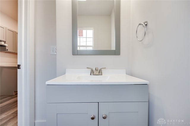 bathroom with vanity and hardwood / wood-style flooring