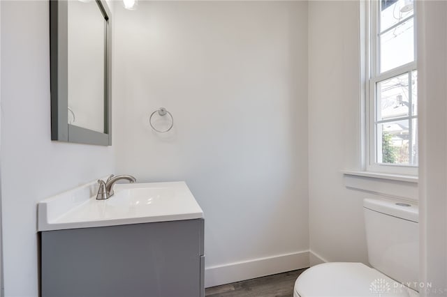 bathroom featuring hardwood / wood-style floors, vanity, and toilet