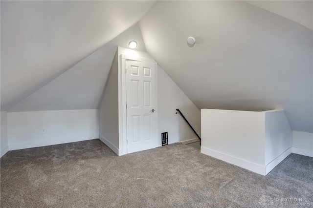 bonus room with carpet and vaulted ceiling