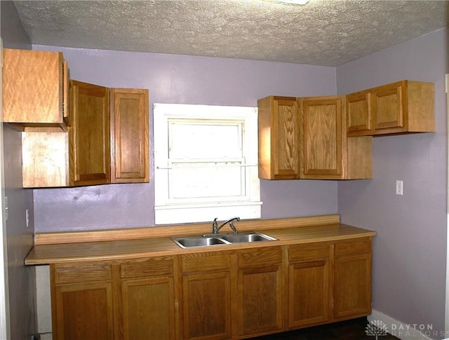 kitchen featuring sink and a textured ceiling