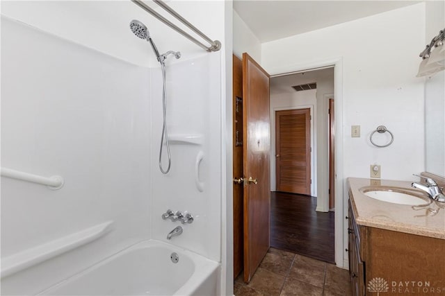 bathroom with tile patterned flooring, vanity, and tub / shower combination