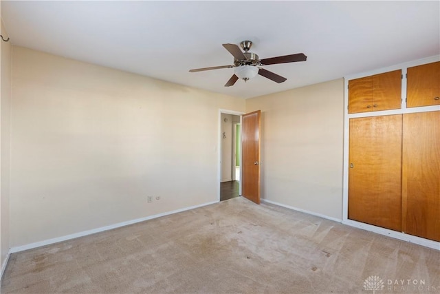 unfurnished bedroom with light carpet and ceiling fan