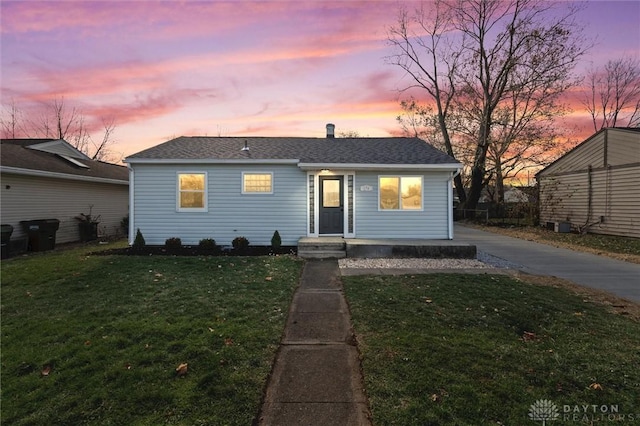 view of front of house featuring entry steps and a yard