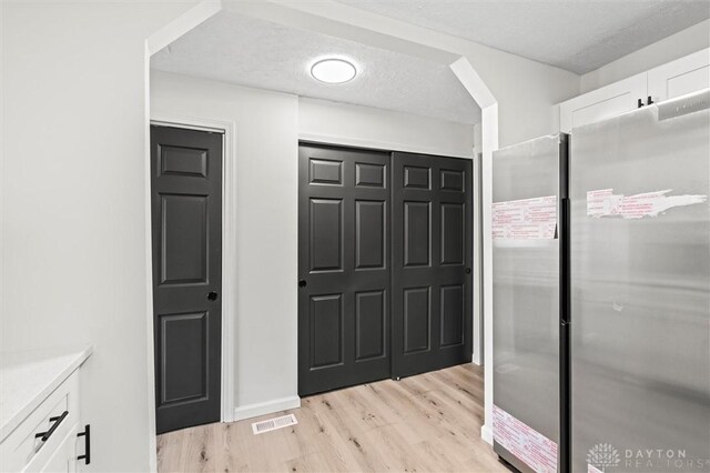 bathroom featuring hardwood / wood-style floors and a textured ceiling