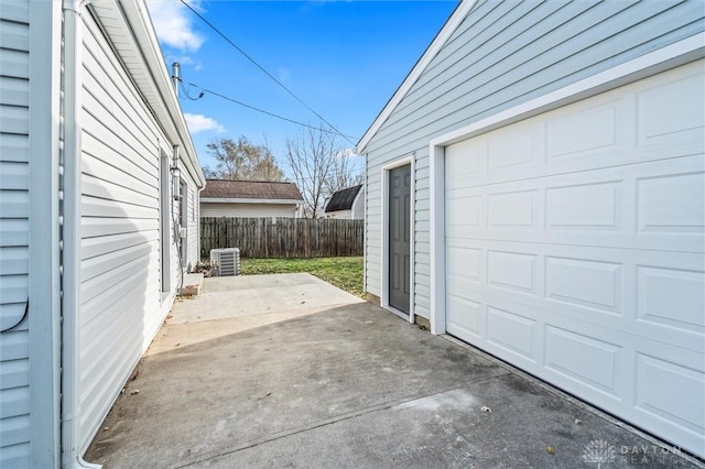 garage with cooling unit and fence