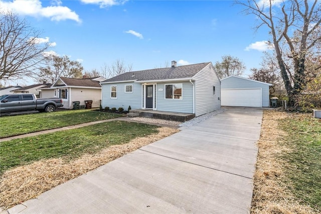 view of front of property with a garage, an outdoor structure, and a front yard