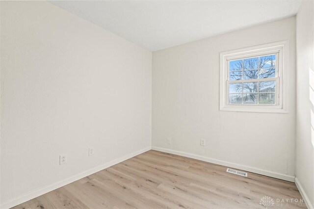 unfurnished room with light hardwood / wood-style flooring