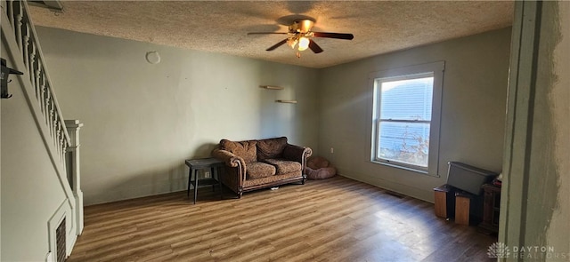 unfurnished room with hardwood / wood-style floors, a textured ceiling, and ceiling fan