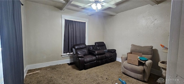 cinema with carpet flooring, ceiling fan, and beamed ceiling