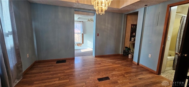 interior space with a chandelier and dark hardwood / wood-style floors