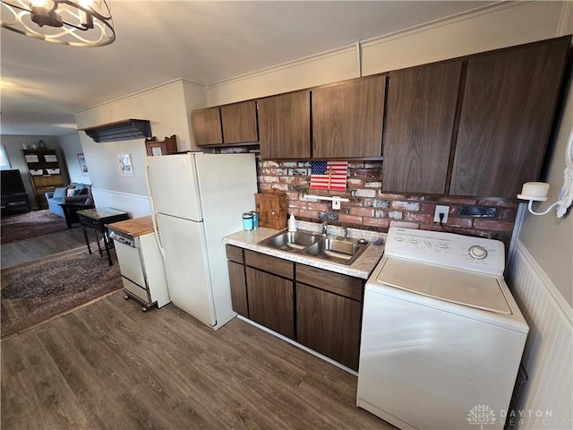 kitchen with washer / dryer, dark hardwood / wood-style flooring, white refrigerator, and sink