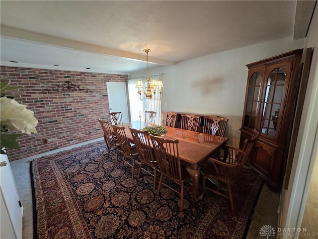 carpeted dining area featuring an inviting chandelier and brick wall