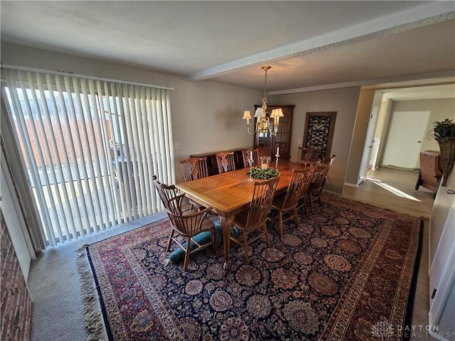 dining room with wood-type flooring, ornamental molding, and a notable chandelier