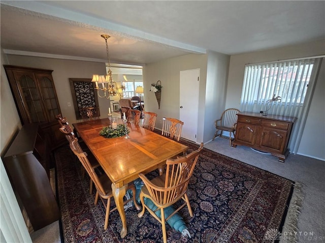 dining room with carpet floors and an inviting chandelier