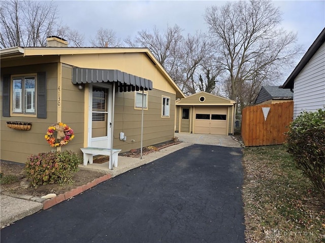 view of side of home with an outdoor structure and a garage