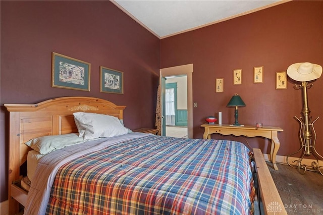 bedroom featuring crown molding and hardwood / wood-style flooring