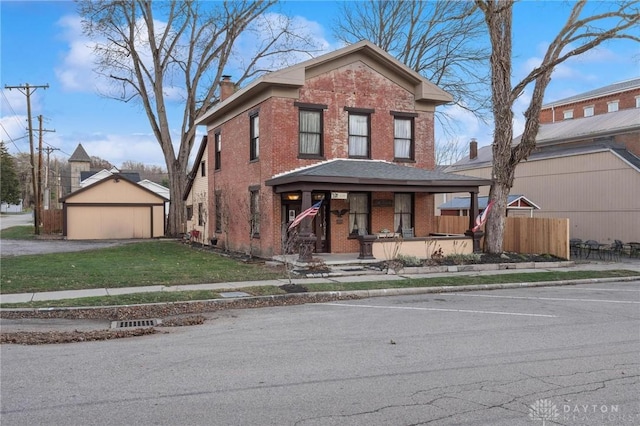 view of front property featuring a garage, a front yard, and a porch