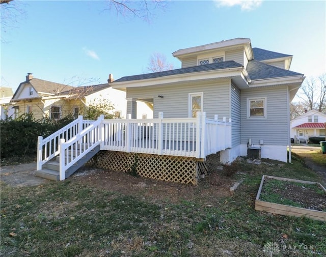 back of property featuring a wooden deck and central AC