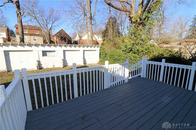 wooden deck featuring a garage