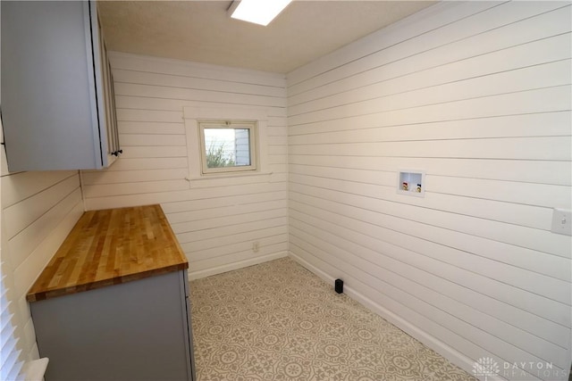 washroom with washer hookup and wood walls