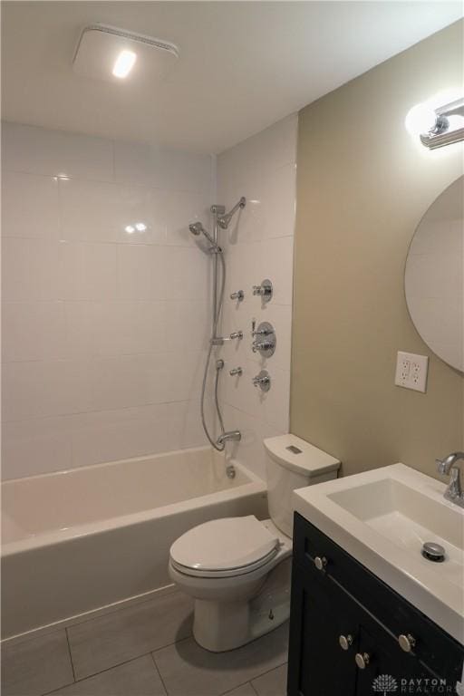 full bathroom with toilet, vanity, tile patterned floors, and tiled shower / bath combo