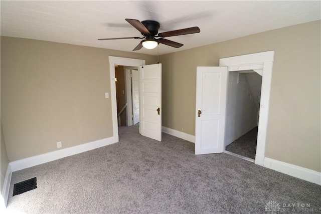 unfurnished bedroom with ceiling fan, carpet floors, and a closet