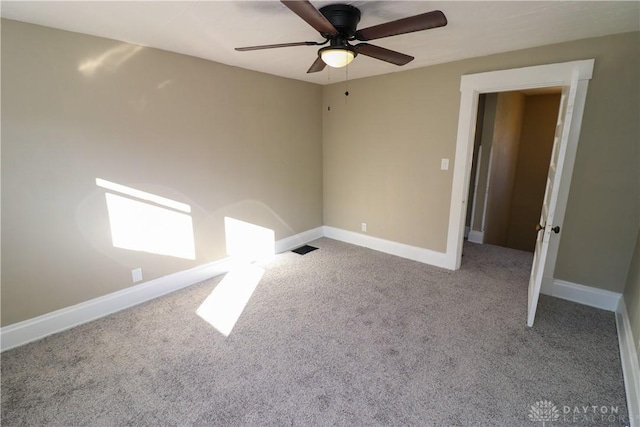 empty room featuring light colored carpet and ceiling fan