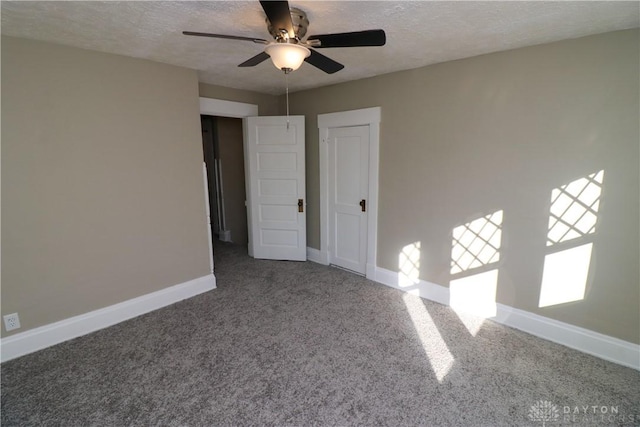 unfurnished room featuring ceiling fan, carpet, and a textured ceiling