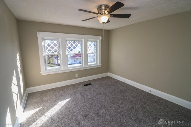 empty room featuring carpet floors and ceiling fan