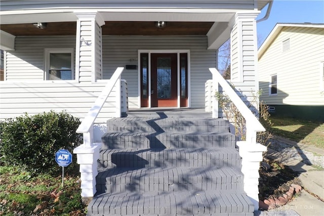 view of exterior entry with a porch