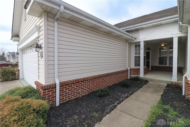 view of home's exterior with a porch and a garage