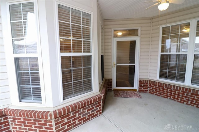 property entrance with ceiling fan and a patio