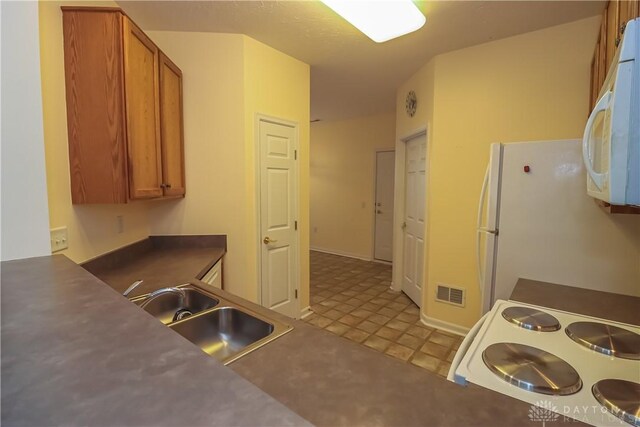 kitchen with sink and white appliances