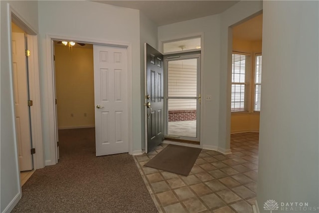 entryway featuring light colored carpet