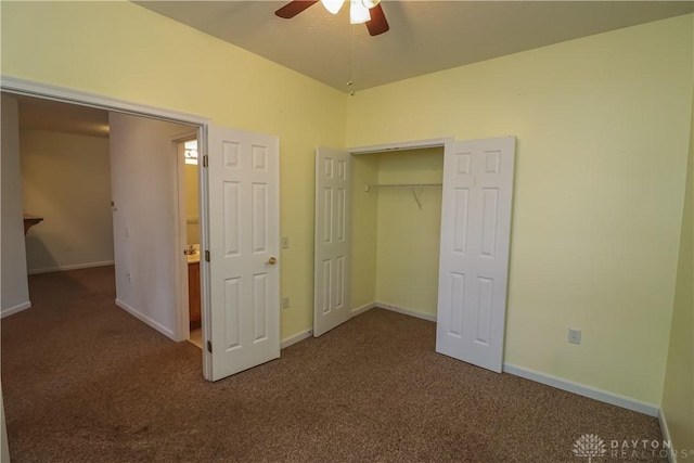 unfurnished bedroom with dark colored carpet, ceiling fan, and a closet