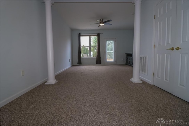 spare room with ceiling fan, ornate columns, and carpet floors