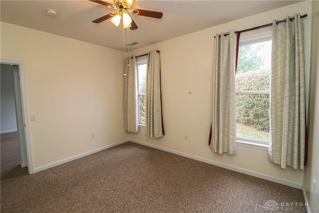 spare room with carpet flooring, plenty of natural light, and ceiling fan