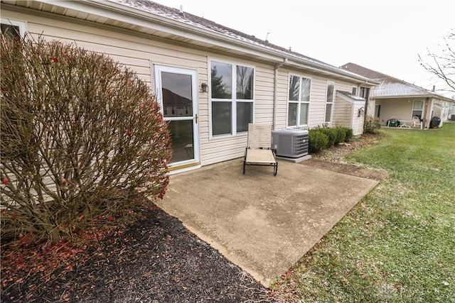 rear view of house featuring a patio area, a yard, and central AC