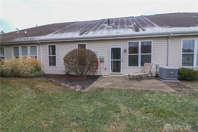 rear view of house featuring a yard, cooling unit, and a patio area