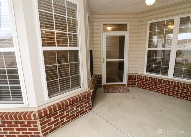 property entrance featuring brick siding