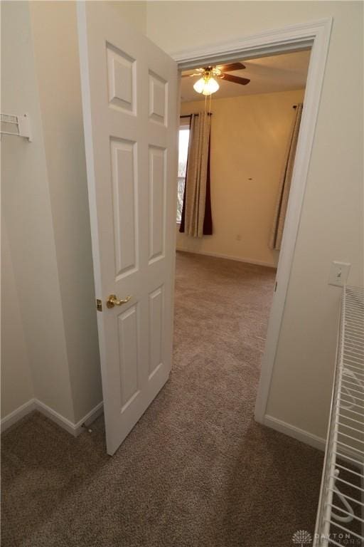 corridor with carpet floors and baseboards