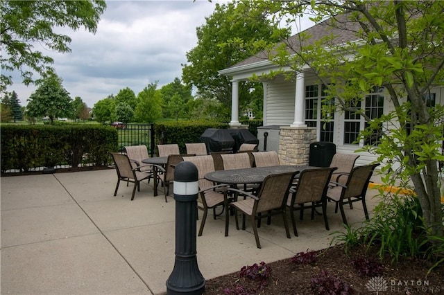 view of patio / terrace with outdoor dining area, area for grilling, and fence